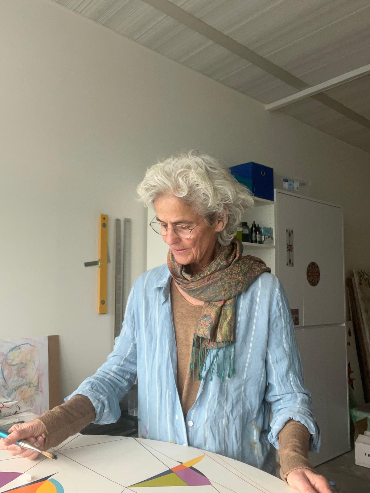 about-the-artist-ruth-painting woman painting at a desk
