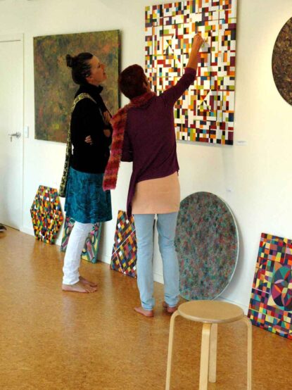 heaven-on-earth-opening two women looking at a geometric painting